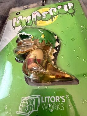 UMASOU Litors Works Green Vinyl dinosaur with little Umasou inside.